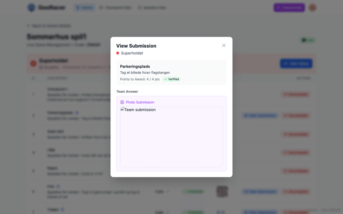 View Submission modal showing the question text, points to award, a Verified badge, and the team’s submitted photo answer.